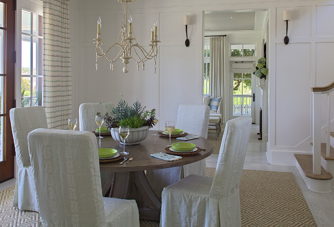 Dining room board and batten wainscoting. Dining room with full wall board and batten wainscoting, lit by Ruhlmann Single Sconces in Bronze. #Dininroom #Boardandbatten #wainscoting #wainscotting #diningroomboardandbatten #diningroomwainscotingwall #diningroomwainscotingideas Urban Grace Interiors