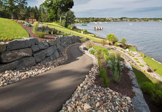 Drop backyard landscaping ideas. The path is wide enough for a golf cart but also makes for beautiful walk down to the lake. The blue-stone wall and variety of perennials and annuals makes for a delightful view for passersby on the lake. Southview Design