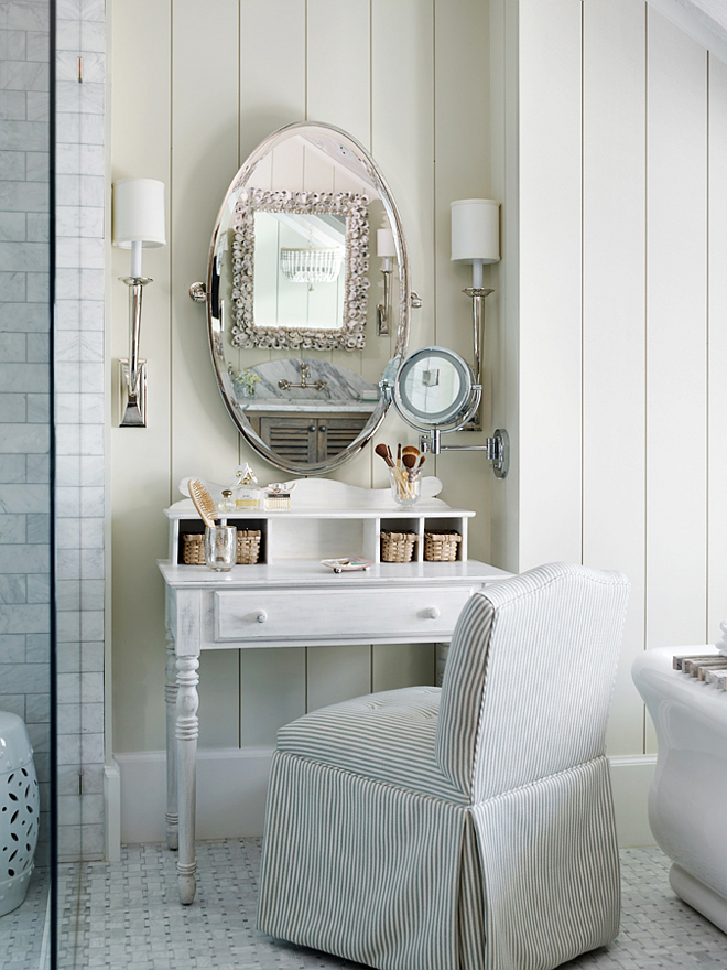 Vanity Table. Vanity. An antique make-up vanity was added to this bathroom to create a special place by the freestanding tub. A slipcovered chair, wall sconces and an oval mirror finishes the look. 