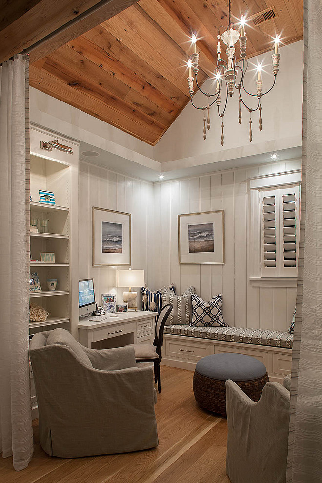 Home Office Den Ideas. Small home office, den with reclaimed plank wood ceiling, vertical shiplap wainscoting and built-in cabinetry. Draperies add some privacy to the space. #homeoffice #den #wainscoting #shiplap #verticalplanks #verticalwallplank #verticalshiplap #reclaimedwoodceiling #reclaimedwood #reclaimedfloors #plankfloor Savoie Architects.