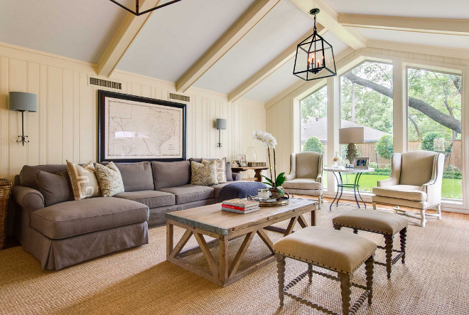 Living room with sisal rug, vaulted ceiling, floor to ceiling window and neutral decor. #livingroo Elizabeth Garrett Interiors.