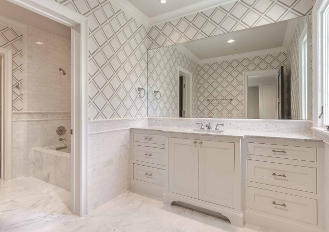 Bathroom with marble floor tiles and half wall marble tile. Wallpaper over half wall tile brings interest to this marble bathroom. #bathroom #marble #halfwall #tiledhalfwall #halfwalltile Elizabeth Garrett Interiors.