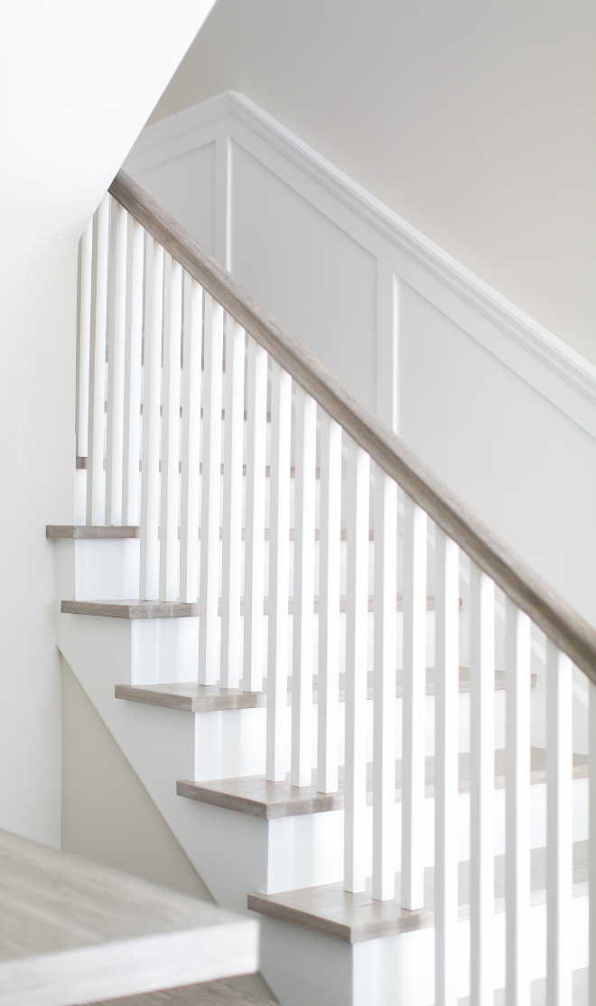 Staircase. The staircase features a clean, neutral look thanks to the square white spindles and white oak handrail and flooring. Patterson Custom Homes. Brandon Architects, Inc.