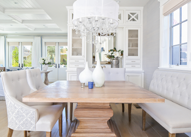 The kitchen opens to a bright dining area with built-in cabinets. Dining room. Dining room banquette style. Patterson Custom Homes. Interiors by Trish Steele, Churchill Design.