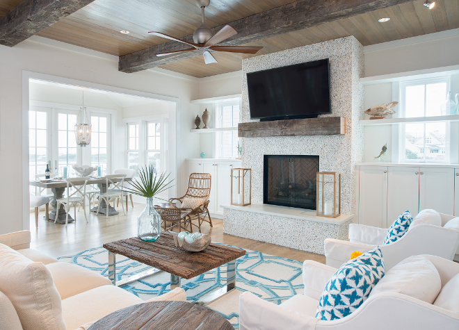  The living room features an inspiring tabby fireplace. Stucco shell fireplace with reclaimed wood beam mantel. Coastal Stucco shell fireplace with reclaimed wood beam mantel. #Stuccoshellfireplace #Stuccosfireplace #shellfireplace #tabbyfireplace. Interiors by Courtney Dickey of TS Adams Studio.