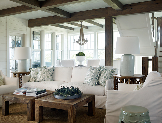 Living room decor tips. In the living room, a white slipcovered sofa and chairs come to balance the natural elements, such as the reclaimed beams and wooden coffee tables. #Livingroom #DecorTips #DecoratingTips #InteriordesignerTips #designertips T.S. Adams Studio, Architects