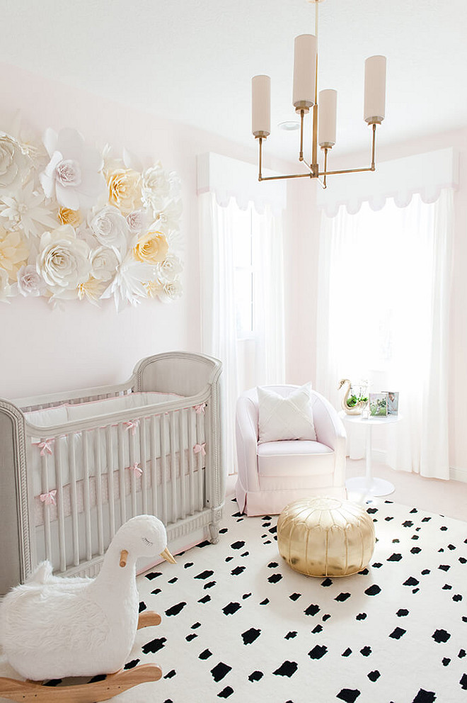 Baby Girl Nursery with soft blush tones and charming swan décor and a paper flower wall. Baby Girl Nursery Design. Blush paint color is Benjamin Moore 2173-70 Gentle Butterfly. #BabyGirl #Nursery #BabyGirlNursery #softblushtones #blushpaintcolor Interiors by Luxe Report Designs. 