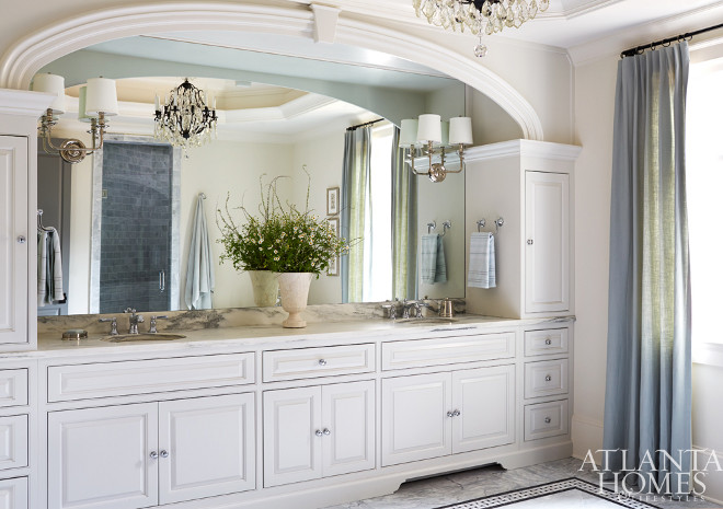 Arched Bathroom Cabinet. His and her sinks with an arched frame. The designer sourced a pair of shaded sconces from Progressive Lighting and had them installed directly onto the mirror to help reflect and spread light throughout the room. Amy Meier for Atlanta Homes & Lifestyles.