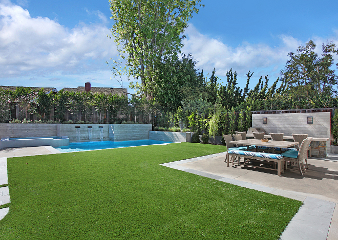 Backyard. This backyard features a bar and BBQ with concrete top and matching concrete table for outdoor dining. Patterson Custom Homes. Interiors by Trish Steele of Churchill Design. 