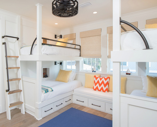 Bunk Room. The bunk room is perfect for the homeowner's grandchildren. It features custom bunk beds with iron railings. Bedding and pillows: Pine Cone Hill. Wood Floors: Character Grade Oak in Heritage finish. Treads on ladder and underneath Bunk Beds: cypress wood. Bunk Bed Hardware: Ashley Norton Hardware. #bunkroom Interiors by Courtney Dickey of TS Adams Studio.