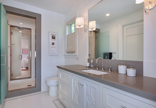 Jack and jill bathroom. This bathroom features white subway tile, with glass wall accent in the center shower, Caeserstone encased shower and vanity top. Closets are by California Closets. Patterson Custom Homes. Interiors by Trish Steele of Churchill Design. 