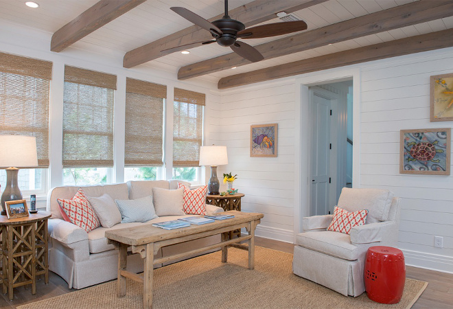 Living room Shiplap walls painted in Benjamin Moore White Dove and oak beams with weathered oak stain. Woven shades are custom. Interiors by Courtney Dickey of TS Adams Studio.