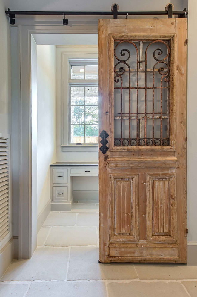 Vintage door hung with barn door hardware. Reclaimed wood vintage door used as sliding door with barn door hardware. #vintagedoor #barndoorhardware #barndoor #doorhardware #hangingvintagedoors #slidingvintagedoor #slidingantiquedoor #slidingdoorhardware Elizabeth Garrett Interiors