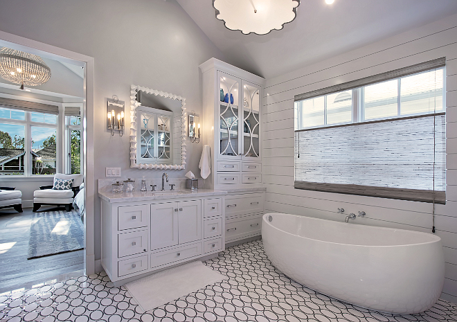 White Master Bathroom Cabinet. The master bathroom features amazing custom water jet floor, free standing tub, beautiful storage and glass cabinetry flank tub. Patterson Custom Homes. Interiors by Trish Steele of Churchill Design. 