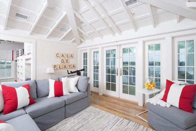 Kids area. Kids area features a bunk room and a tv room with ocean view. Sectional and chair are from Mitchell Gold. Pillows are custom. Rug is Dash and Albert and side table is from Room and Board. Interiors by Courtney Dickey of TS Adams Studio.