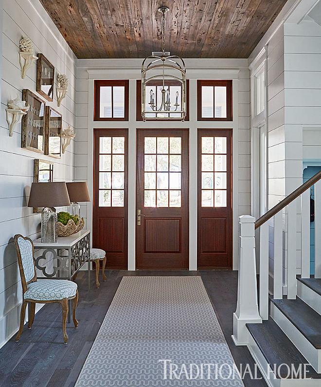 Foyer with shiplap walls and reclaimed plank wood ceiling. The foyer features some stunning architectural details such as shiplap walls and reclaimed Pecky Cypress wood ceiling. #Foyer #shiplapwalls #foyershiplap #shiplap #reclaimedwoodceiling #plankwood #ceiling #plankwoodceiling #plankceiling #PeckyCypress #PeckyCypresswood #PeckyCypressceiling