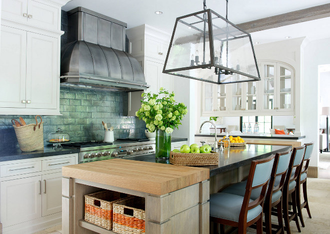 Industrial Farmhouse Kitchen. Kitchen. Countertops are Belgian Bluestone. The backsplash tile is Terra Cuite, Black Metal, 4 x 8 from Paris Ceramics. The hood was custom made by Focal Metals. It is stainless steel with a pewter finish in both brushed and matte. The linear hand-forged iron light fixture is by Gregorius/Pineo and is the Vassaro Chandelier. Industrial Farmhouse Kitchen. Industrial Farmhouse Kitchen. Industrial Farmhouse Kitchen #Industrial #Farmhouse #Kitchen #IndustrialKitchen #Farmhouse #Farmhousekitchen