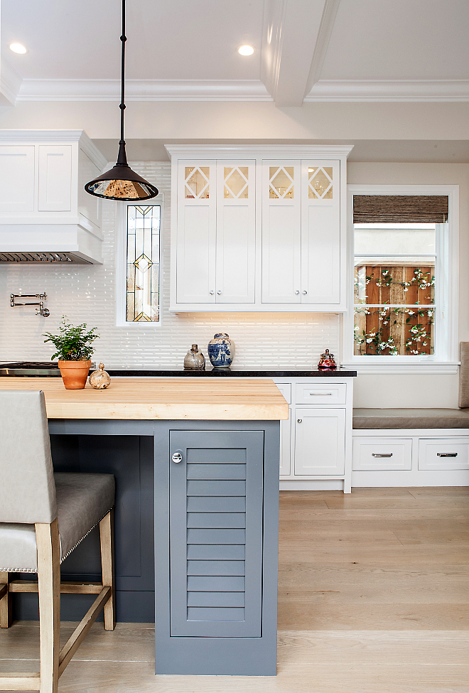 White kitchen with gray island paint color. White kitchen cabinet paint color is Benjamin Moore Decorator's White. Gray island paint color is Benjamin Moore Kendall Charcoal. #WhiteKitchen #PaintColor #BenjaminMooreDecoratorsWhite #Darkgrayisland #BenjaminMooreKendallCharcoal #Kitchen