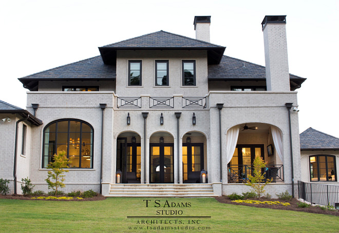 This classic home features brick exterior painted in an ivory white and slate roof. #paintedbrick #brickexterior #slateroof TS Adams Studio Architects. Traci Rhoads Interiors.