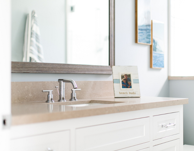 Bathroom Quartz Countertop. Countertop is Caesarstone quartz. The custom mirror is made of reclaimed wood. #bathroom #quartz #caesarstone Churchill Design.
