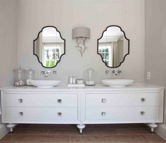 Bathroom cabinet. This bathroom features double vanity unit with counter top sink and wall mounted faucets. Hayburn & Co. 