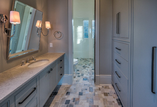 Bathroom cabinets. Bathroom cabinet ideas. Bathroom features a long vanity and a storage cabinet across vanity. #Bathroom #Cabinet #Storage