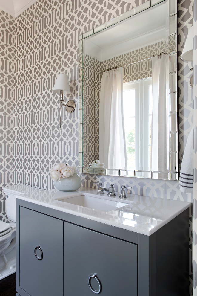 Gray Powder room. This gray powder room features Kelly Wearstler Imperial Trellis Wallpaper in Charcoal. A pair of Waterworks Newell Single Arm Sconces with Cone Shades is placed over a dark gray vanity with polished nickel ring pulls and white marble countertop. #gray #powderroom #bathroom #vanity #wallpaper #graybathroom #graypowderRoom TS Adams Studio Architects. Traci Rhoads Interiors.