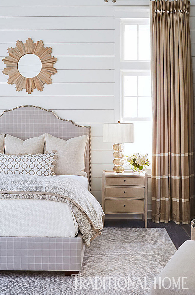 Bedroom. Neutral and monochromatic bedroom. Neutral and monochromatic bedroom ideas. The nailhead-trim headboard creates a sinuous line against the shiplap wall paneling. An Arteriors lamp sits on a nightstand from Gabby. Neutral and monochromatic bedroom design #Neutral #monochromatic #bedroom #interiors