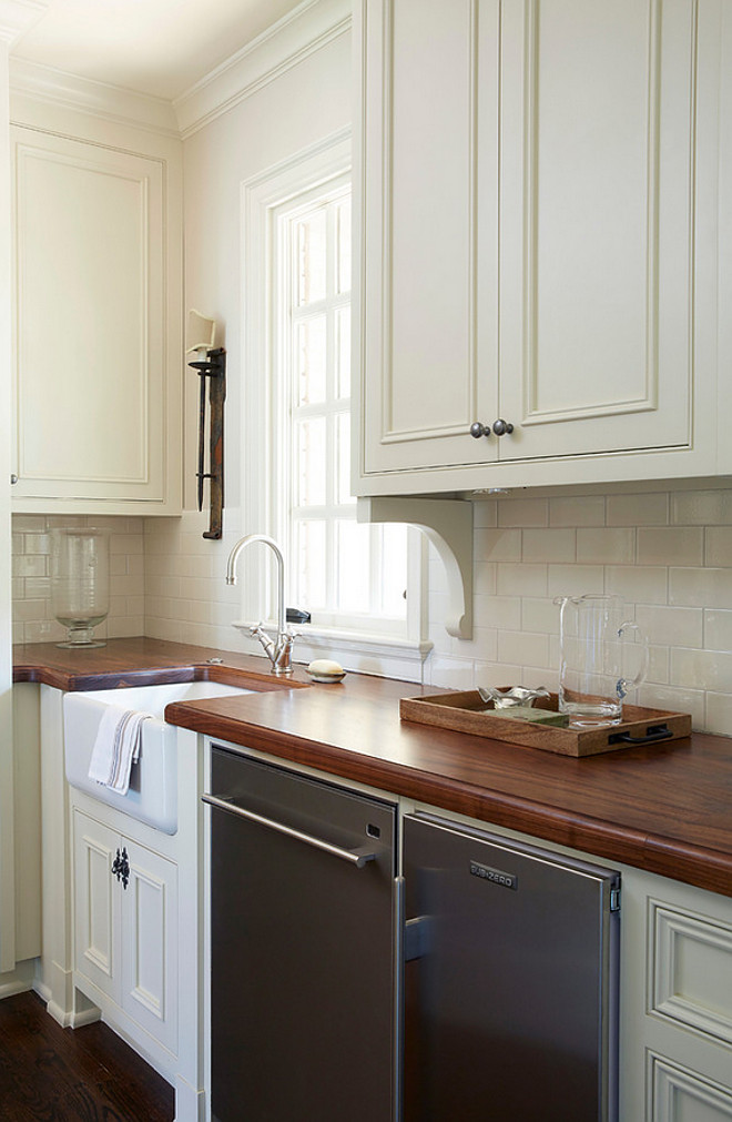 Butler's pantry farmhouse sink, Black Walnut Countertop and off-white cabinets and off-white tile backsplash. #Butlerspantry #farmhousesink #BlackWalnut #countertop #offwhite #cabinet #tile #backsplash