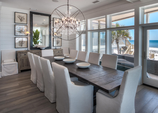 Dining Room. Modern Coastal Dining room with tongue and groove wall paneling, slipcovered linen chairs and wide plank floors. #diningroom #moderndiningroom #moderncoastal #coastalinteriors #tongueandgroove #wallpaneling #wideplank