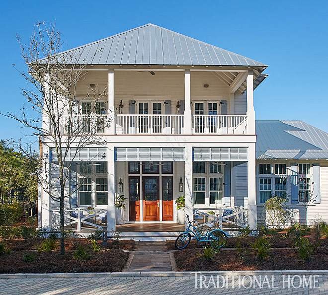 Florida Vacation Beach House. A two-level porch spans the front of the home. Florida Vacation Beach House Exterior #FloridaHome #VacationHome #BeachHouse. Traditional Home - T.S. Adams Studio.