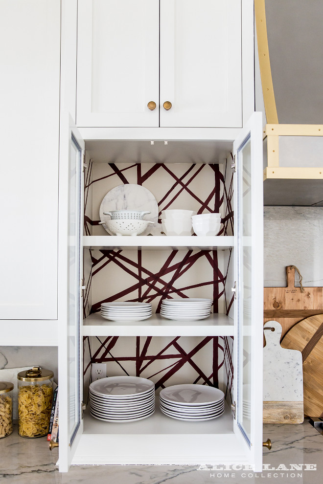 Kelly Wearstler Channels Wallpaper. Kitchen features glass door cabinets with backs of shelves lined with an abstract wallpaper -- Kelly Wearstler Channels Wallpaper. Alice Lane Home.