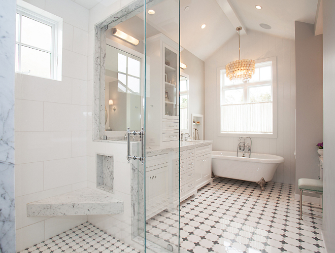 Master Bathroom. This master bathroom is a tile and stone lover's heaven! The floor is made up of Thassos, Carrera, and London Grey marble laid in a gardenia pattern. The counter, shower jamb, and shower seat are Venatino Marble, and the shower walls & ceiling are Thassos honed in 12x24" tiles. #MasterBathroom #Bathroom #shower #tiles #flooring Patterson Custom Homes