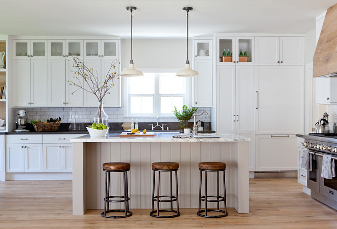 Modern Farmhouse kitchen. The shaker style cabinetry was made in walnut, and painted in Benjamin Moore’s “Decorators White”. This is one of the designer's favorite whites because it reflects the natural light so beautifully and looks really fresh in a kitchen. Modern white Farmhouse kitchen. Modern Farmhouse kitchen with white cabinets. #ModernFarmhouse #FarmhouseKitchen #Whitefarmhousekitchen Kate Lester Interiors