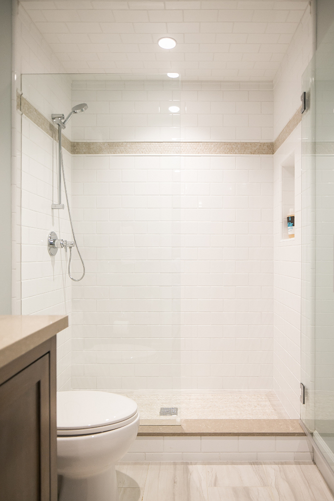Neutral Bathroom Tiling Combination. Bathroom feature off-white subway tiles, neutral floor tiles and neutral quartz countertop. Churchill Design 