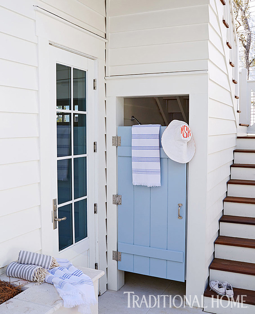 Outdoor Shower. Behind a blue door, an outdoor shower is tucked under the stairway. #Outdoorshower #beachhouse