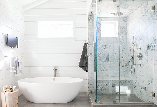 Shiplap bathroom. Minimalist shiplap bathroom with oval tub and marble shower with bench and rain shower. #bathroom #shiplap #minimalist #marble #shower Elizabeth Brooke Design. Photo by Ryan Garvin.
