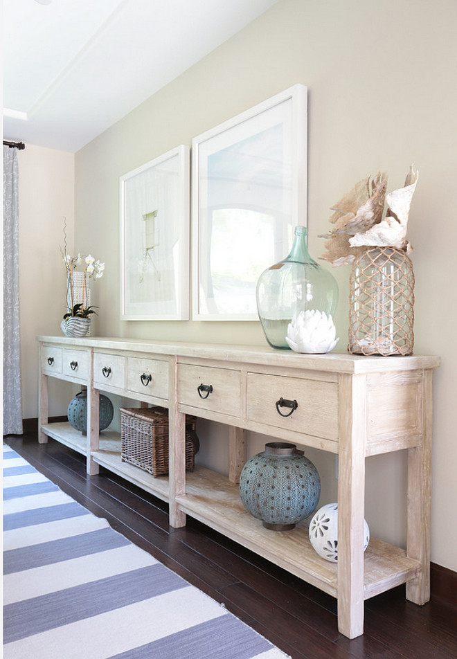 Sideboard. Long sideboard. Dining room features long sideboard with whitewash finish and coastal decor. #sideboard #longsideboard #whitewash Blackband Design