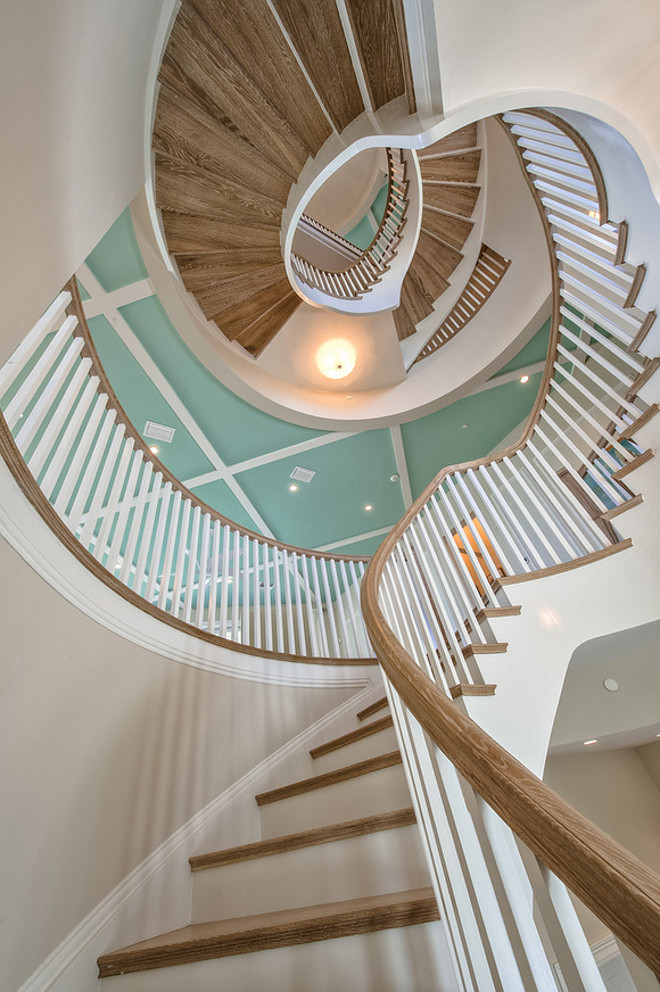 Staircase Millwork. The central staircase is the focal point of this home. Ceiling paint color is Sherwin Williams Aloe and wall paint color is Sherwin Williams SW7555 Patience. #Staircase