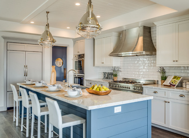 Three paint colors used in the kitchen. Gray lower cabinets and fridge panels paint color is Benjamin Moore Nimbus. White upper cabinets paint color is Benjamin Moore White Dove. Blue island paint color is Benjamin MooreEvening Dove. #Kitchen #paintcolors Titan & Co