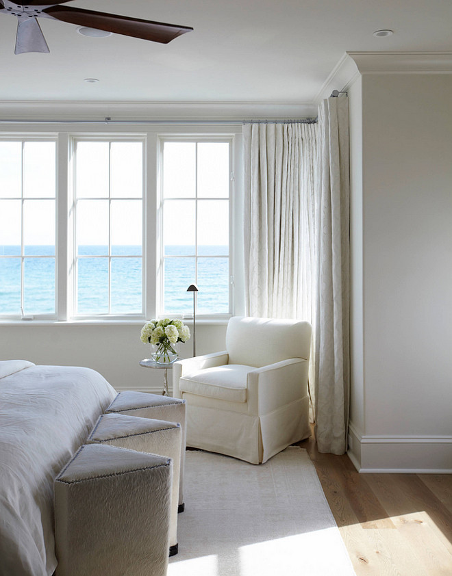 White Bedroom. White bedroom with ocean view. White bedroom with ivory white walls, ivory white draperies and white slipcovered bedding and white bedding. #Whitebedroom #ivorywhitebedroom #white #bedroom #interiors