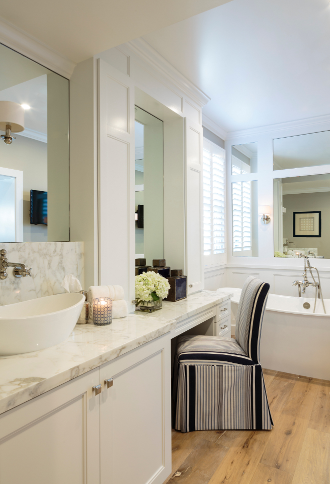 Bathroom. Bathroom with hardwood floors. Small Bathroom with hardwood flooring and white cabinetry. The master bathroom has a serene and organic feel thanks to the white cabinetry, marble counters and wide hardwood floors. #Bathroom #hardwoodfloors Designed by Barclay Butera.