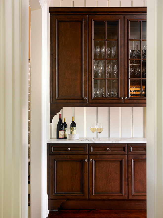 Butler's Pantry. Butler's Pantry with dark stained cabinet and white marble countertop. Marble countertop is Calcutta Danby. Wall paint color is Benjamin Moore OC-8 Elephant Tusk. #ButlersPantry #darkcabinet T.S. Adams Studio. Interiors by Mary McWilliams from Mary Mac & Co.