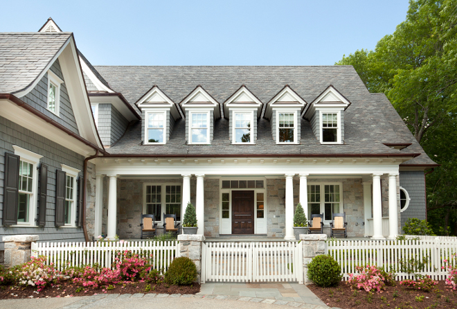Front yard with picket fence. Picket fence. Traditional home with front porch and picket fence. #picketfence T.S. Adams Studio. Interiors by Mary McWilliams from Mary Mac & Co.