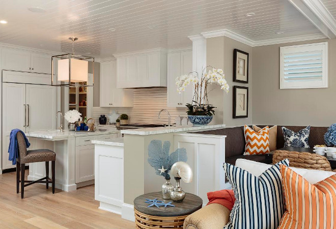 Kitchen and breakfast nook with beadboard ceiling. White beadboard ceiling in kitchen and breakfast nook with banquette. Designed by Barclay Butera.