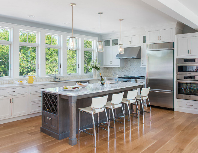 Kitchen. This kitchen feels open and airy. The wall paint color is C-2 Seraph. Trim paint color (for whole house) is "Benjamin Moore OC-67 Ice Mist". Cabinets: Cabinets are White Inset Starmark - White Inset DeWitt Door. Island: Island is Starmark Gray Stain with Pewter Glaze. #kitchen #openkitchen #airykitchen #kitchenpaintcolor Caldwell & Johnson Custom Builders & Remodelers