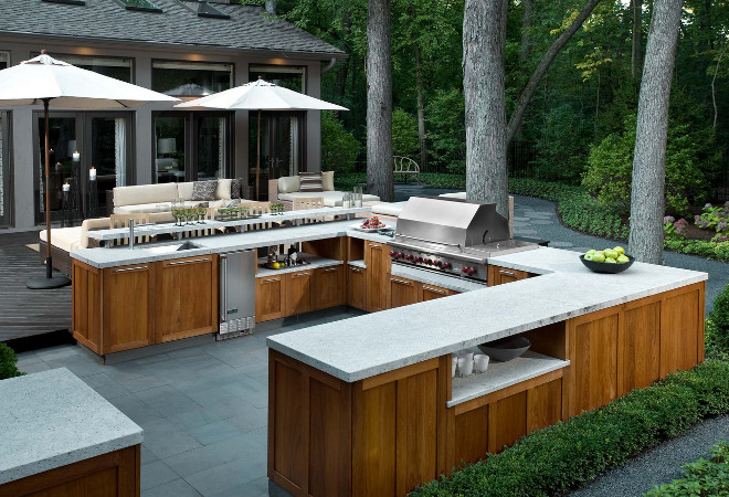 Outdoor kitchen cabinet. An additional challenge for the design team was to ensure that the kitchen would withstand the harsh Chicago elements; the countertop was done in honed granite and the cabinetry is marine-grade teak. To bring the modern design into harmony with the natural surroundings, a neutral palette was selected to complement the aesthetic inside the home without detracting from the lush green of the outdoor space. #outdoorkitchen #cabinet Fredman Design Group