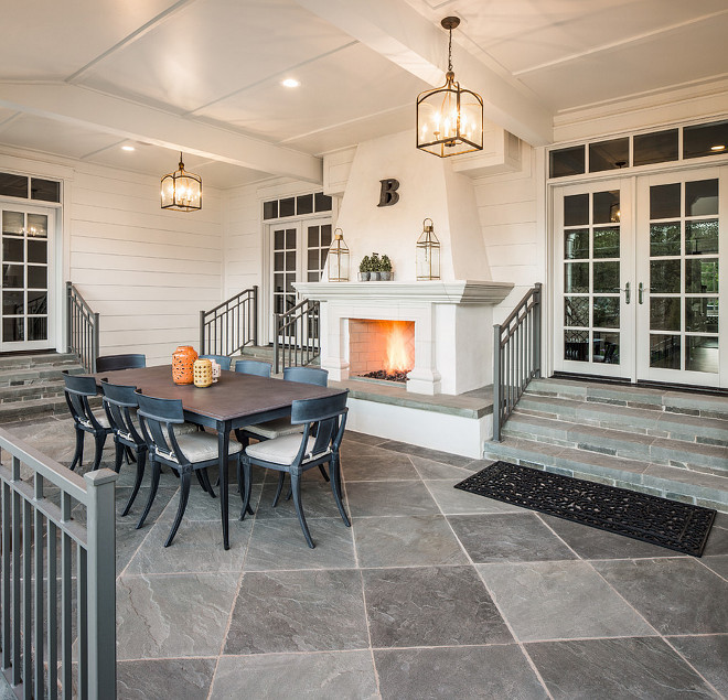 Porch fireplace and slate floor tile. Beautiful porch fireplace, slate floor tile and vaulted ceilings with lantern pendant lights. #porch #fireplace #slatefloortile #floortile #tile #vaultedceiling Fox Group Construction