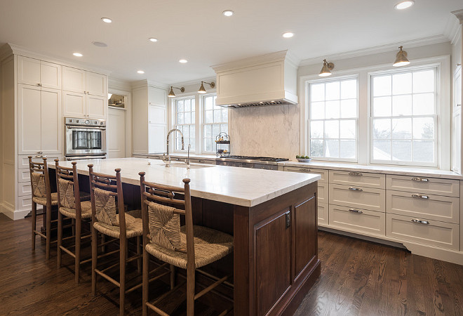 White Dove by Benjamin Moore kitchen cabinets with walnut stained kitchen island. Northstar Builders, Inc.