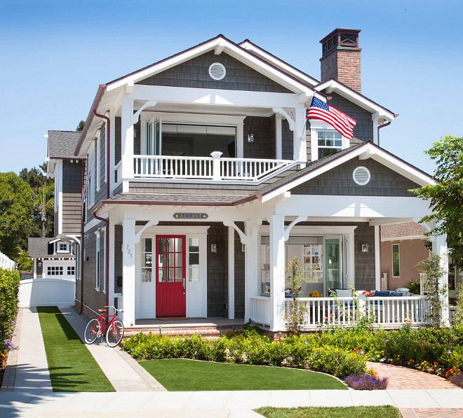American Flag Porch Ideas. Coastal home with American Flag, Porch. American Flag front of house with a red front door to match. Americana. #AmericanFlag #Porch #RedDoor #FrontDoor #Facade Flagg Coastal Homes